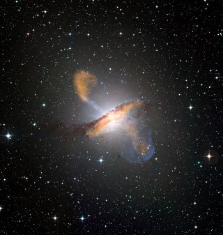 Merging X-ray data (blue) from NASA’s Chandra X-ray Observatory with microwave (orange) and visible images reveals the jets and radio-emitting lobes emanating from Centaurus A's central black hole. 