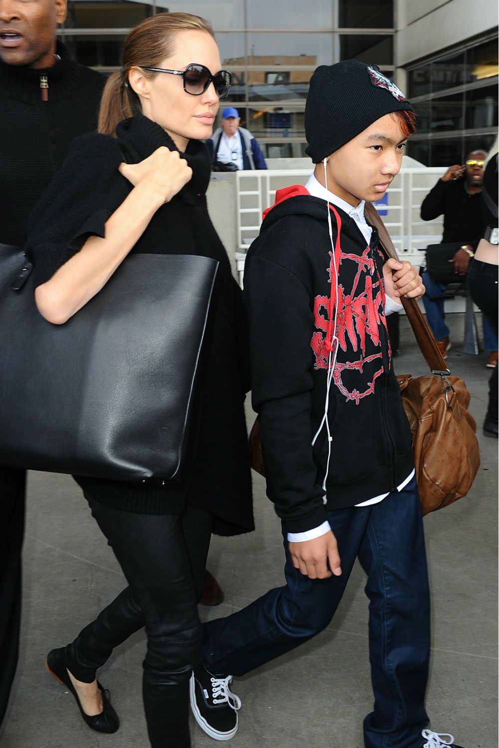 Angelina Jolie, Brad Pitt and Maddox arrive at LAX.