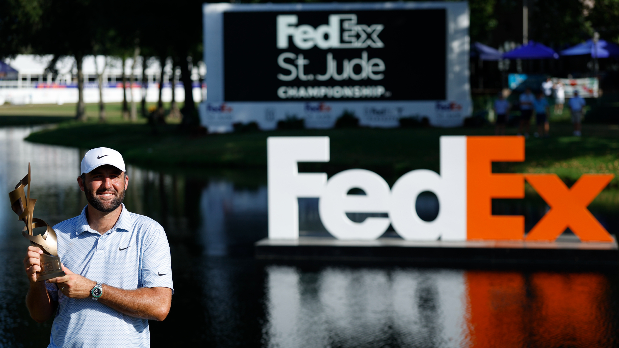 Scottie Scheffler holds the FedEx St. Jude Championship trophy
