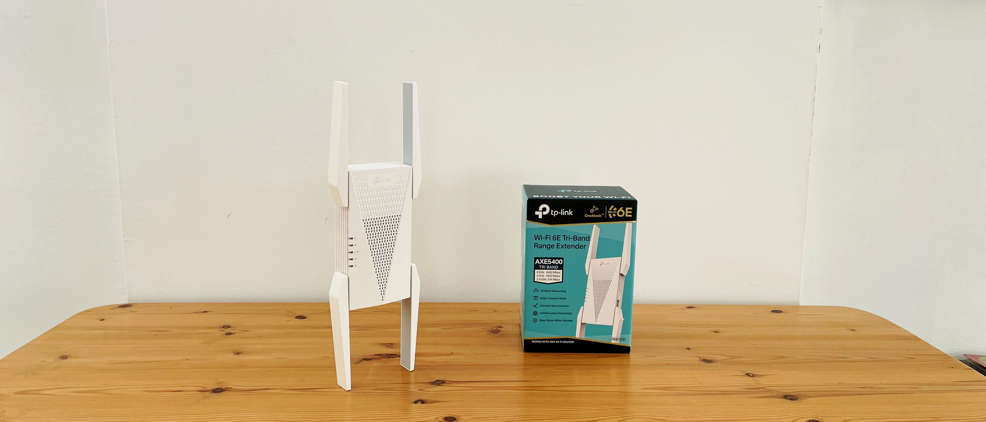 TP-Link AXE5400 range extender on wooden table