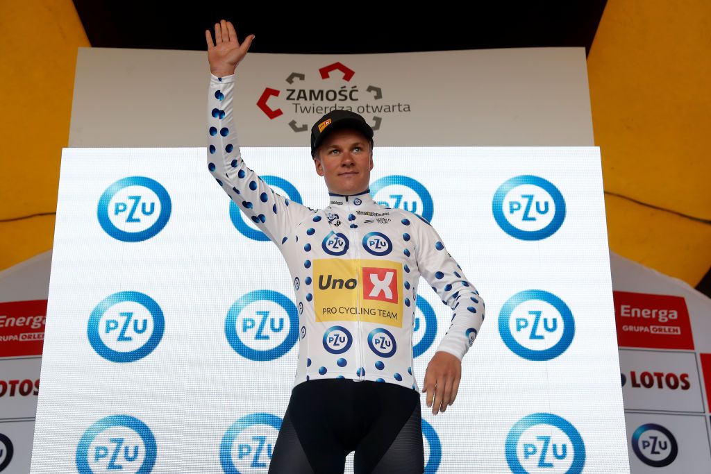ZAMOSC POLAND JULY 31 Jonas Abrahamsen of Norway and UNO X Pro Cycling Team celebrates winning the Polka Dot Mountain Jersey on the podium ceremony after the 79th Tour de Pologne 2022 Stage 2 a 2056km stage from Chem to Zamo TdP22 WorldTour on July 31 2022 in Zamosc Poland Photo by Bas CzerwinskiGetty Images