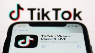 TikTok app on a phone with the TikTok logo in the background