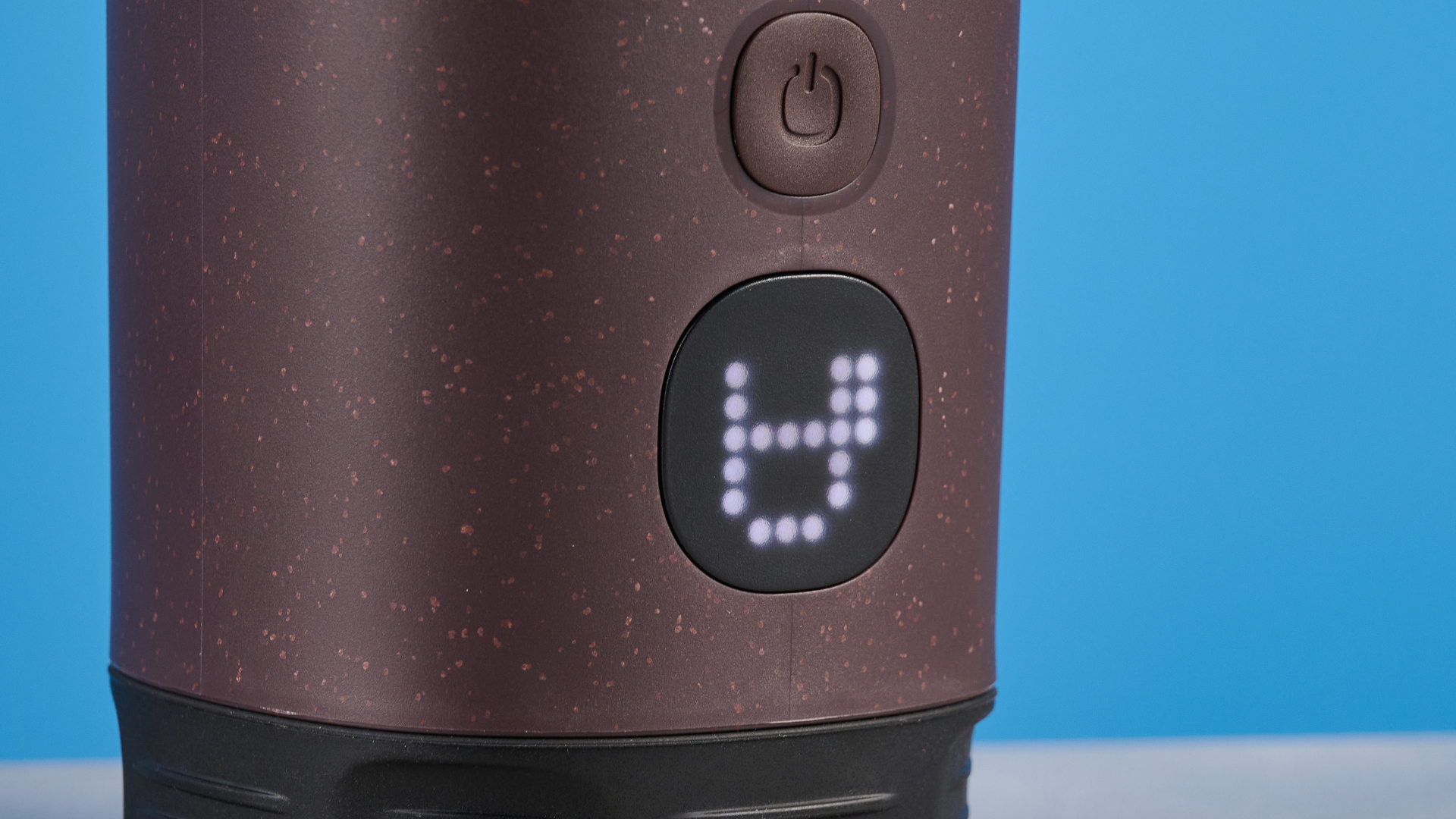 the wacaco pixapresso portable self-heating espresso maker in dark purple color showing usability with nespresso pods and ground coffee, ideal for vacations and camping