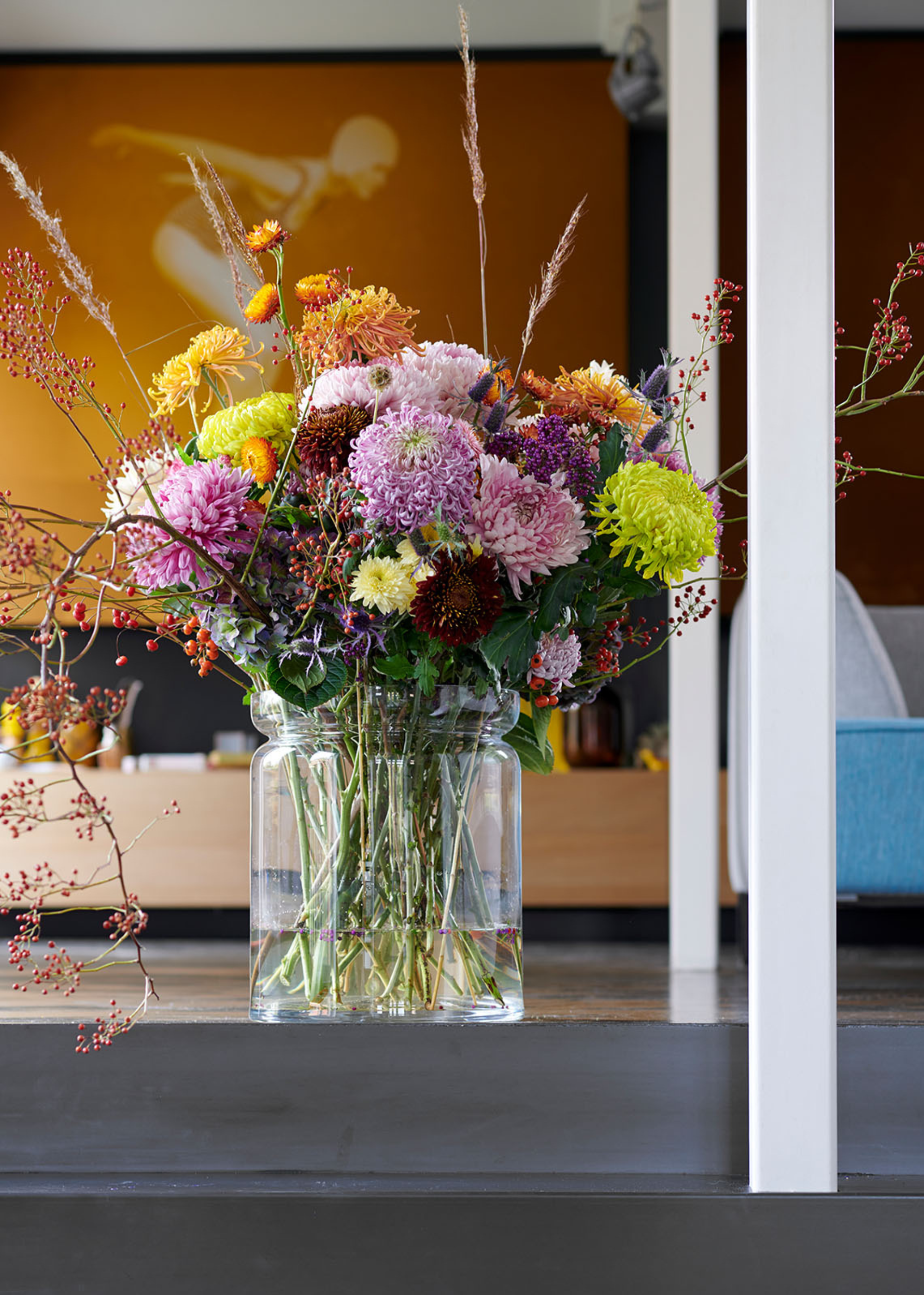 A glass vase of colorful carnations