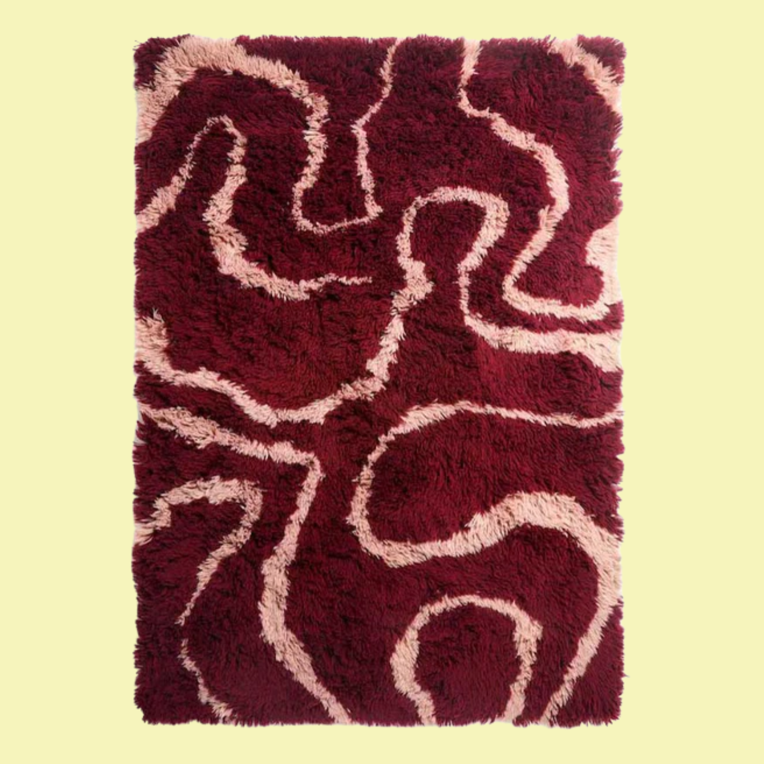 A fuzzy burgundy and pink swirl rug