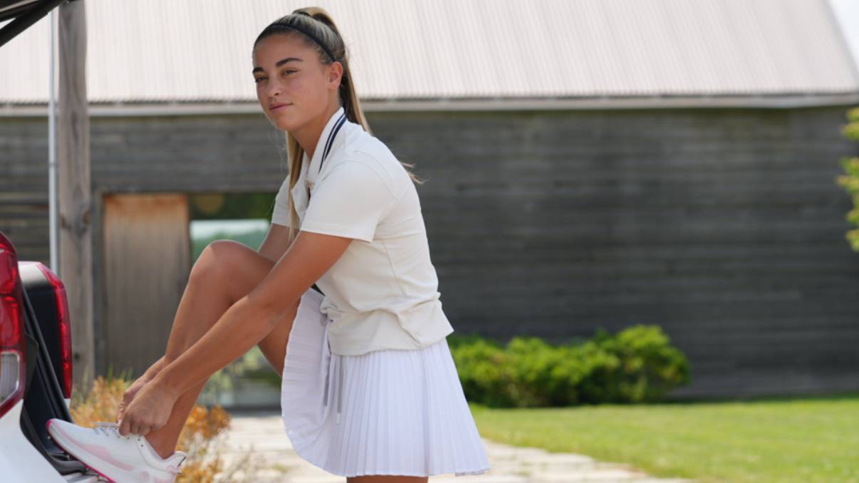 Gabby Golf Girl tying her shoe laces up