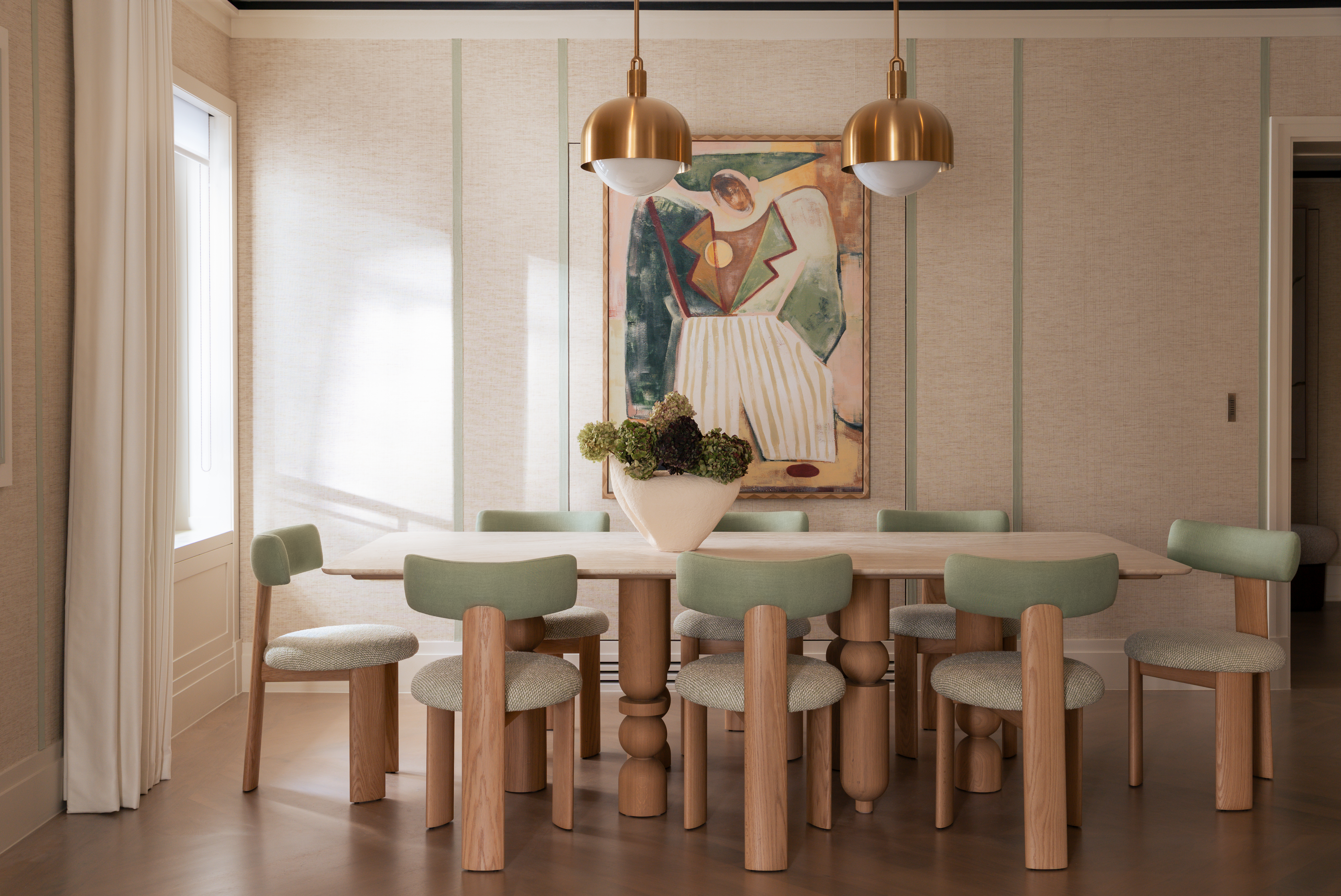 large dining room with pale green and wood dining chairs and modern wood dining table