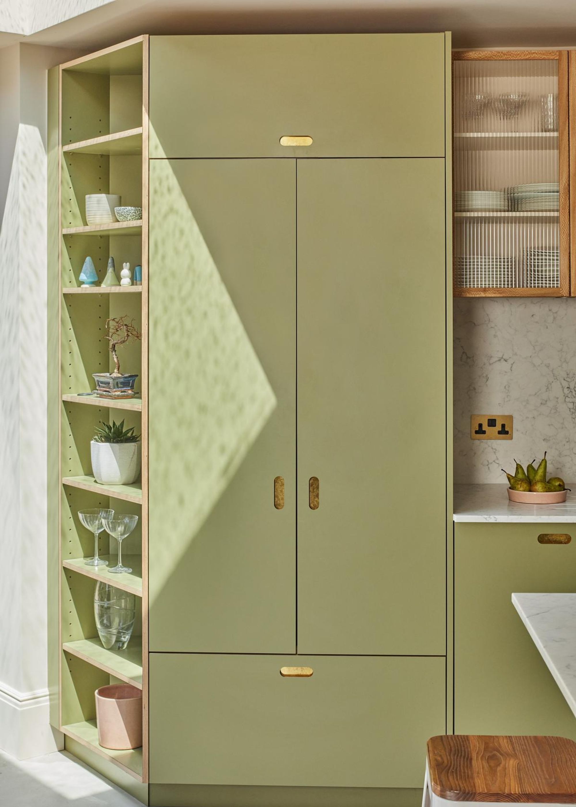 A pantry with a corner of shelves from top to bottom with kitchen essentials on top