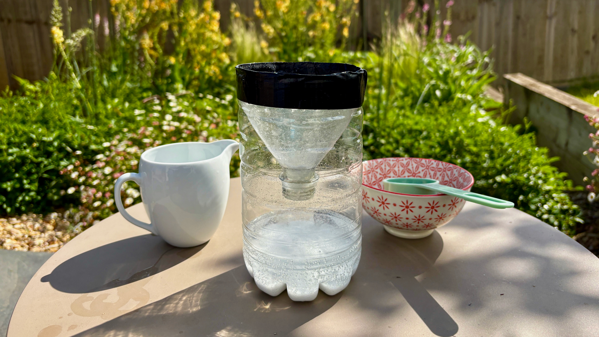 DIY mosquito trap made using upcycled plastic bottle, white vinegar and baking soda
