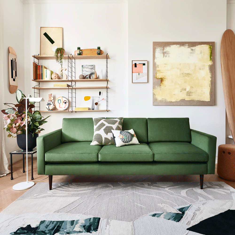 living room with green sofa and wooden flooring