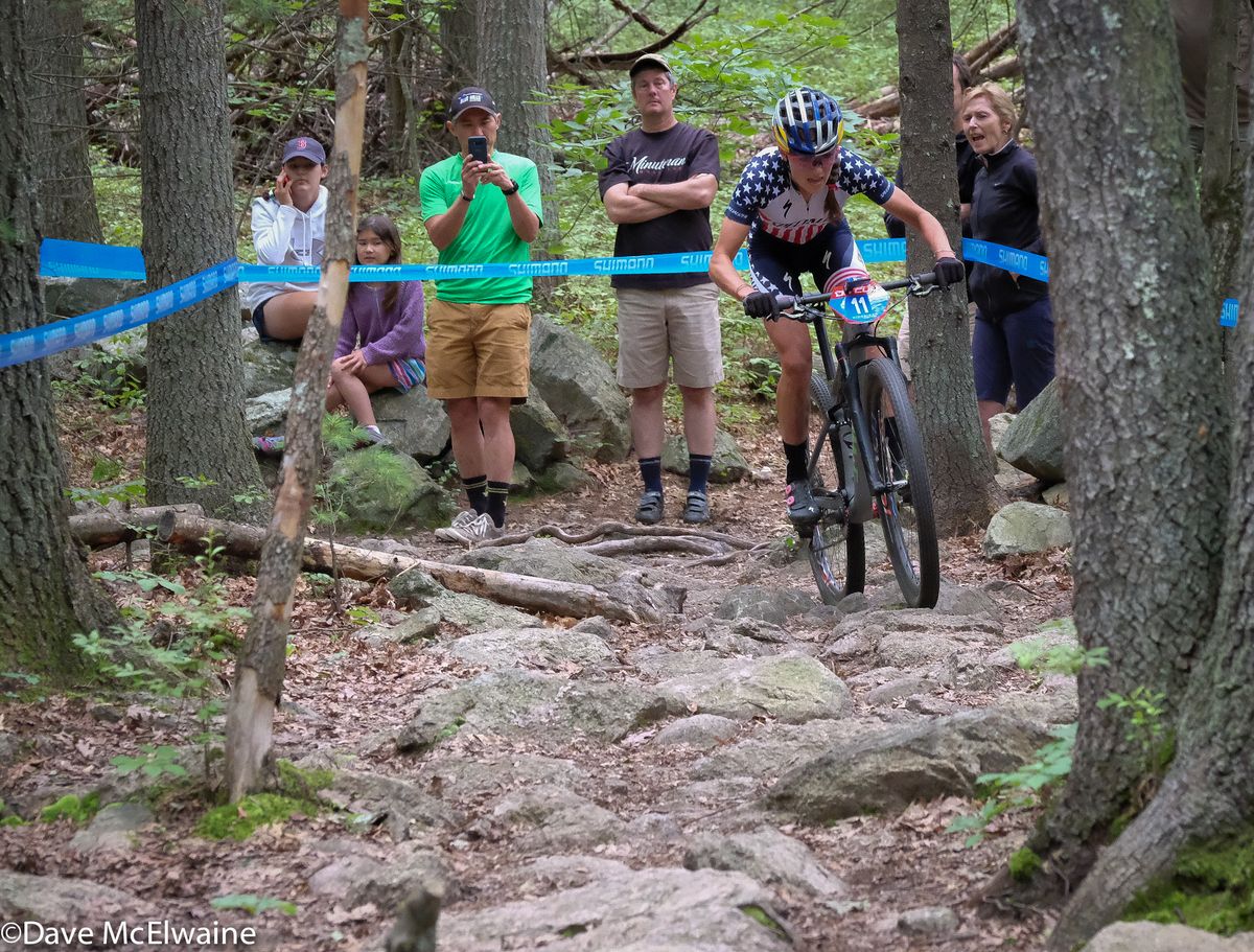 Kate Courtney (Specialized) riding one of the rock gardens with one lap remaining