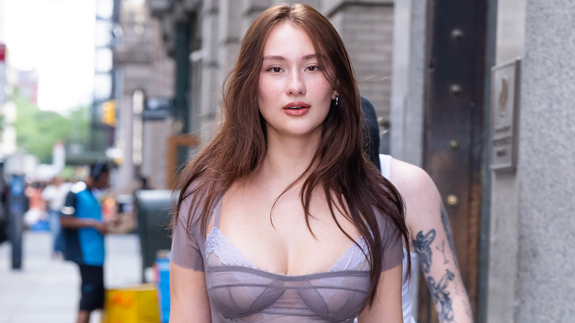 Lola Tung styled the peekaboo bra trend under a lavender-tinted naked dress 