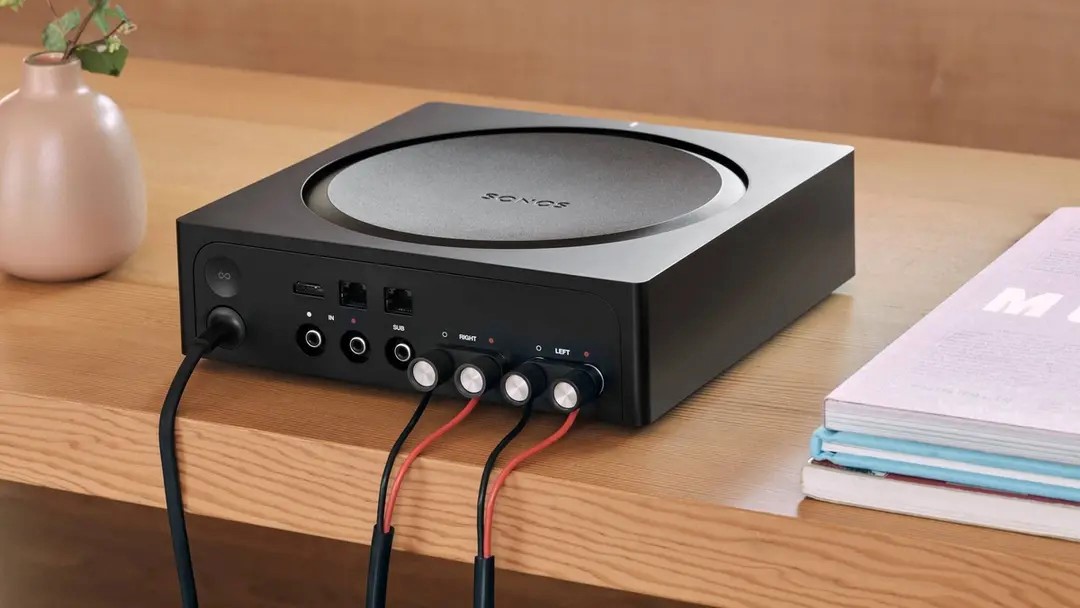 Lifestyle setting showing back of Sonos Amp showing ports and cable connections