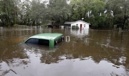 A truck and home swamped with floodwater near Florence, South Carolina.