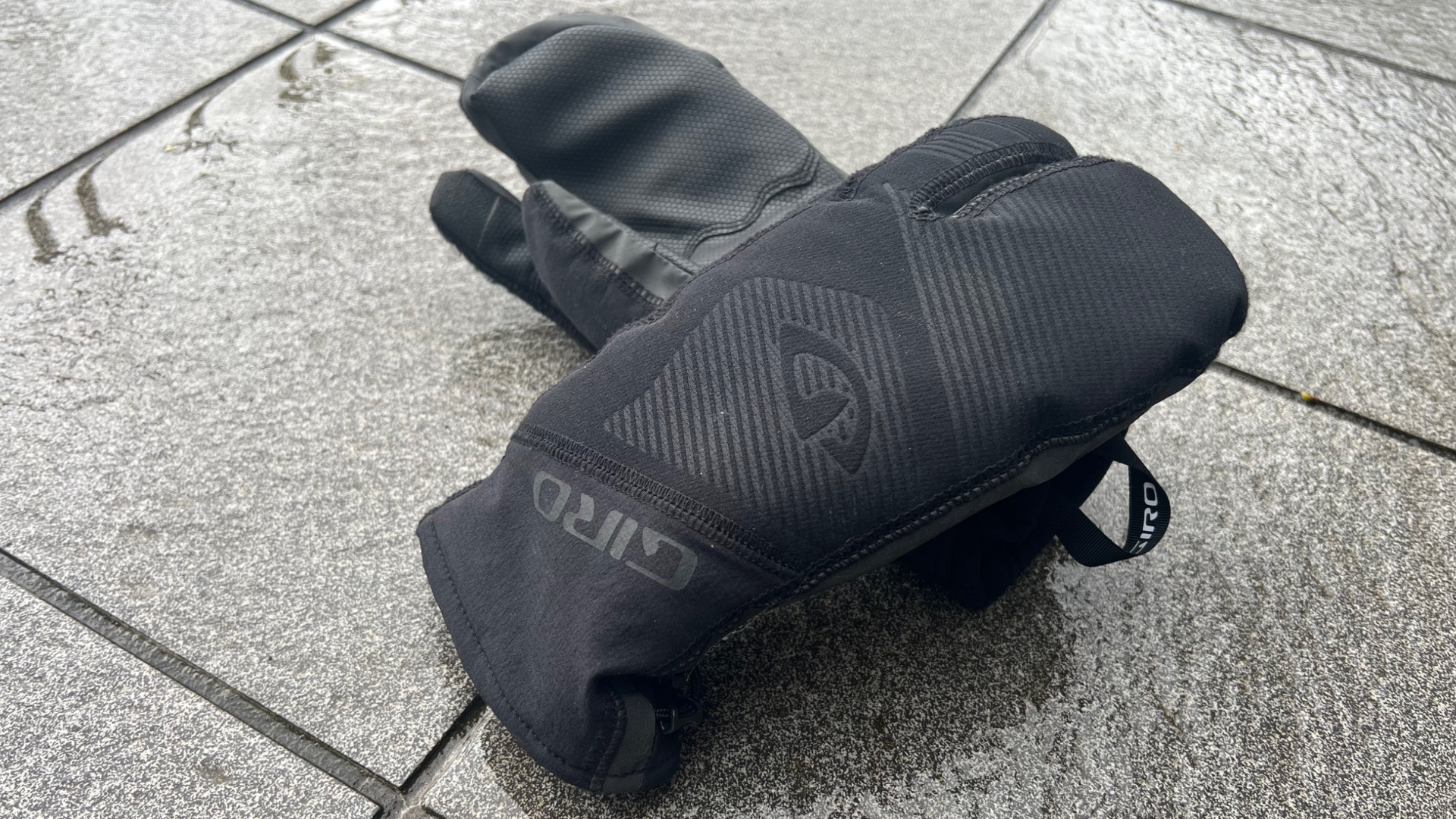 The Giro 100 Proof winter gloves on a wet tiled floor