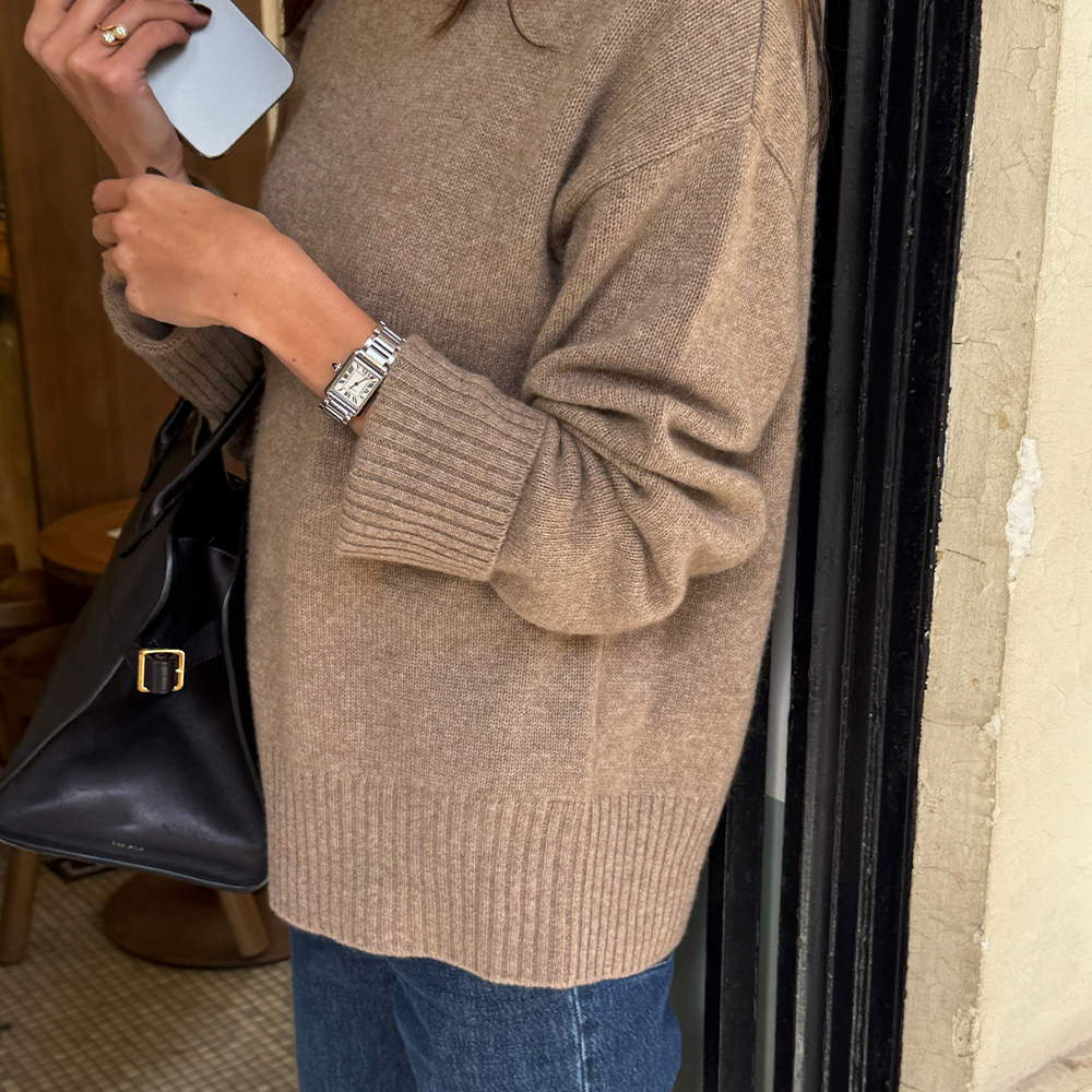 @fakerstrom wearing a sweater, jeans, and The Row bag