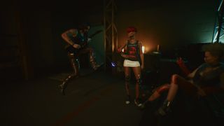 Johnny Silverhand, a rockerboy from Cyberpunk 2077, hits a sick riff in front of two unimpressed looking ladies.