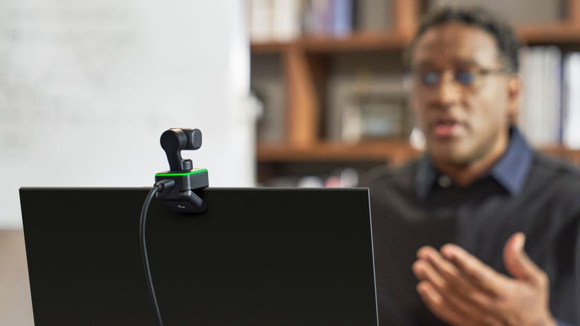 A person presenting in front of the Insta360 Link webcam