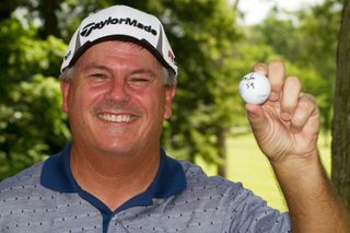 Paul Goydos holds up his golf ball