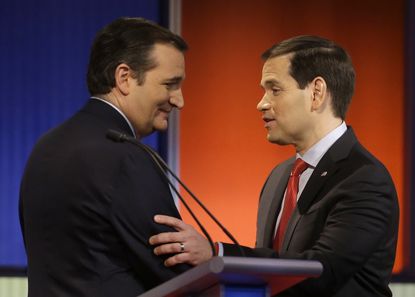 Ted Cruz and Marco Rubio talk after a Republican presidential primary debate, Jan. 28, 2016, in Des Moines, Iowa