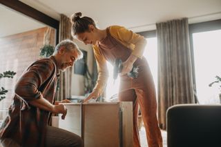 teen girl holding a drill, upcycling furniture with her father