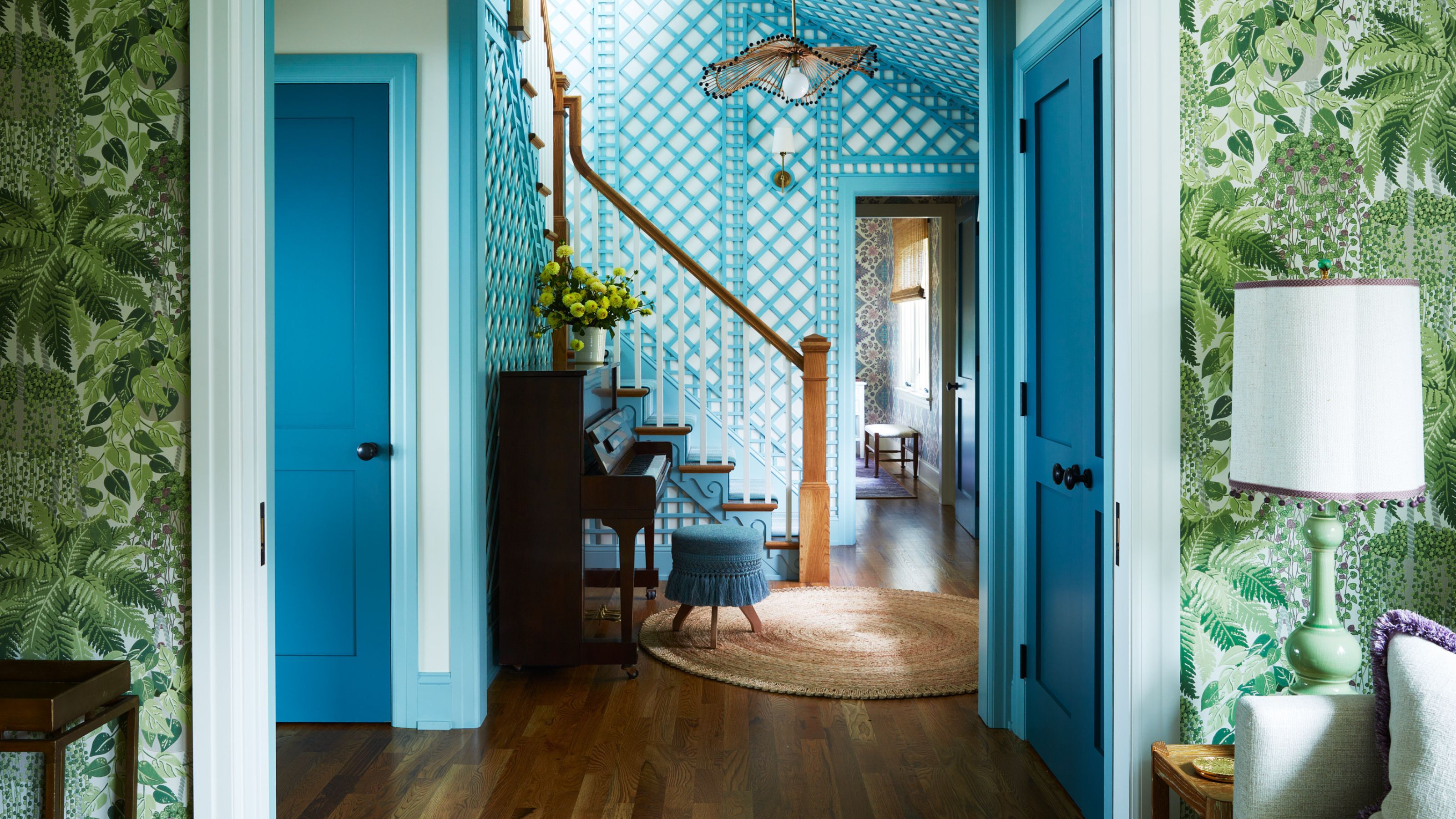 view through to home entry color drenched in teal blue with print on wall