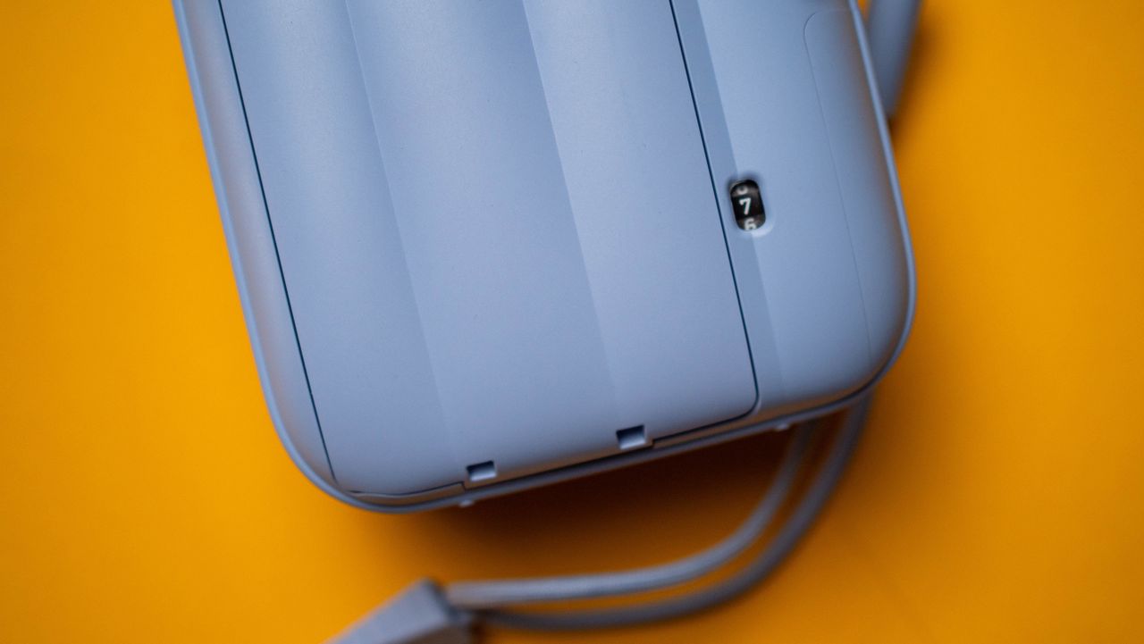 Fujifilm Instax Mini 13 instant camera against a yellow colored sheet