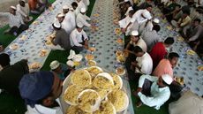 Asian Muslims break their fast in a food hall on the first Friday of the holy month of Ramadan in Dubai, 14 September 2007. The world's 1.2 billion Muslims marked the first Friday of the holy