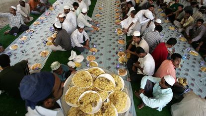 Asian Muslims break their fast in a food hall on the first Friday of the holy month of Ramadan in Dubai, 14 September 2007. The world's 1.2 billion Muslims marked the first Friday of the holy
