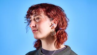 the samsung galaxy buds 4 pro in white photographed against the blue tom's guide background