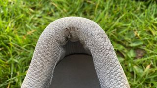 A worn out heel of a golf shoe