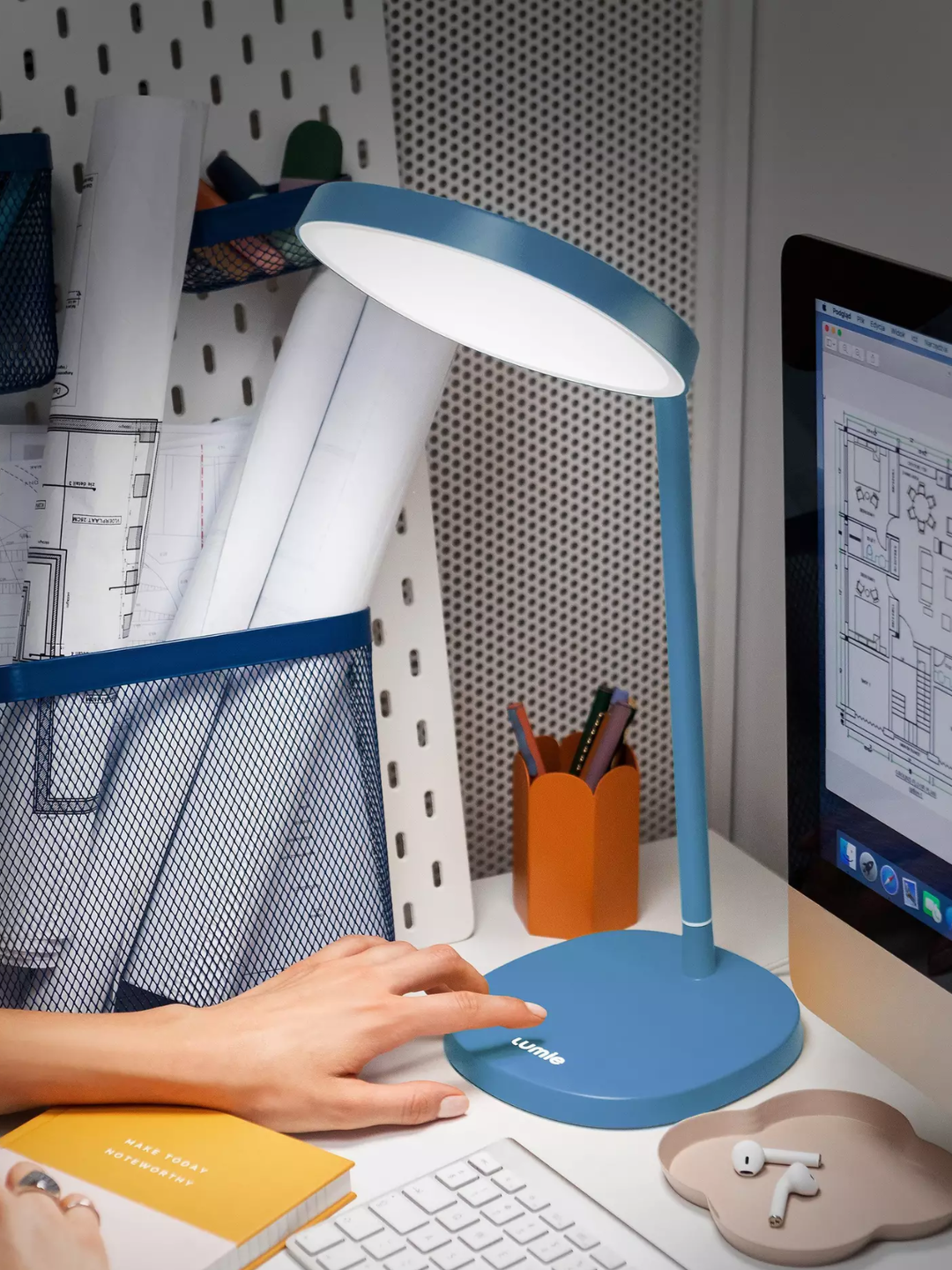 A blue light therapy desk lamp in a study space from Lumie