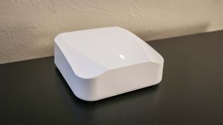 A Wyze Mesh Router placed on furniture