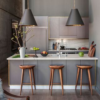 grey kitchen with cabinets and hanging lights