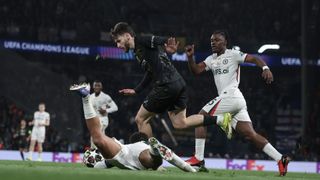 PSG's Khvicha Kvaratskhelia dribbling past Chelsea players in the 2025/26 Champions League