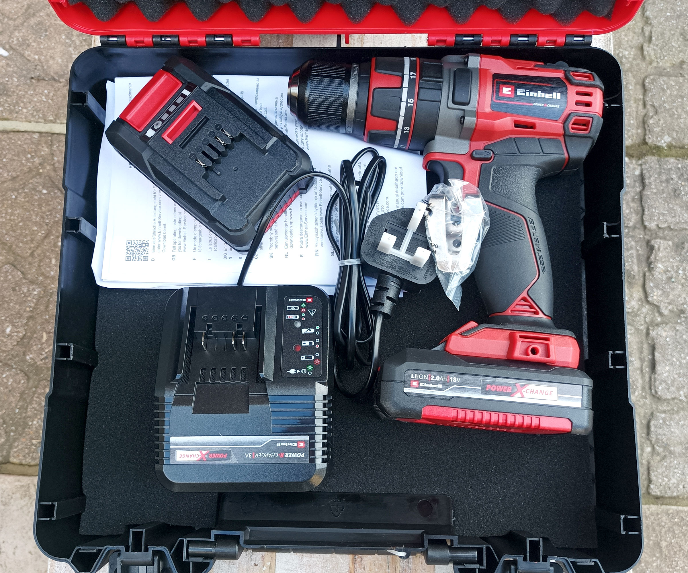 Top down shot of Einhell TP-CD 18/50 cordless drill, battery charger and batteries in hard case