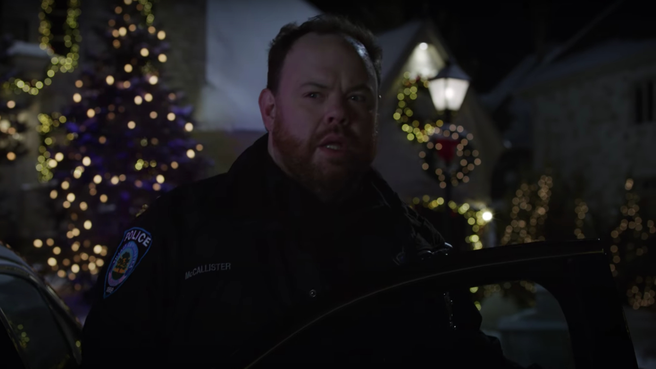 Devin Ratray stands by his car looking surprised in Home Sweet Home Alone.