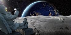 An astronaut sits on the moon recording the sunrise on earth with a smartphone.