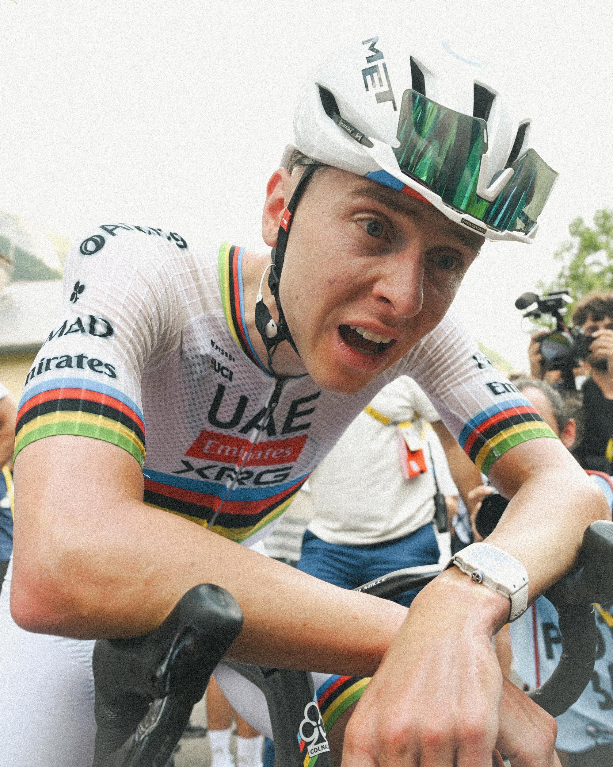 Tadej Poga&amp;#269;ar hunches over his handlebars looking exhausted by heat