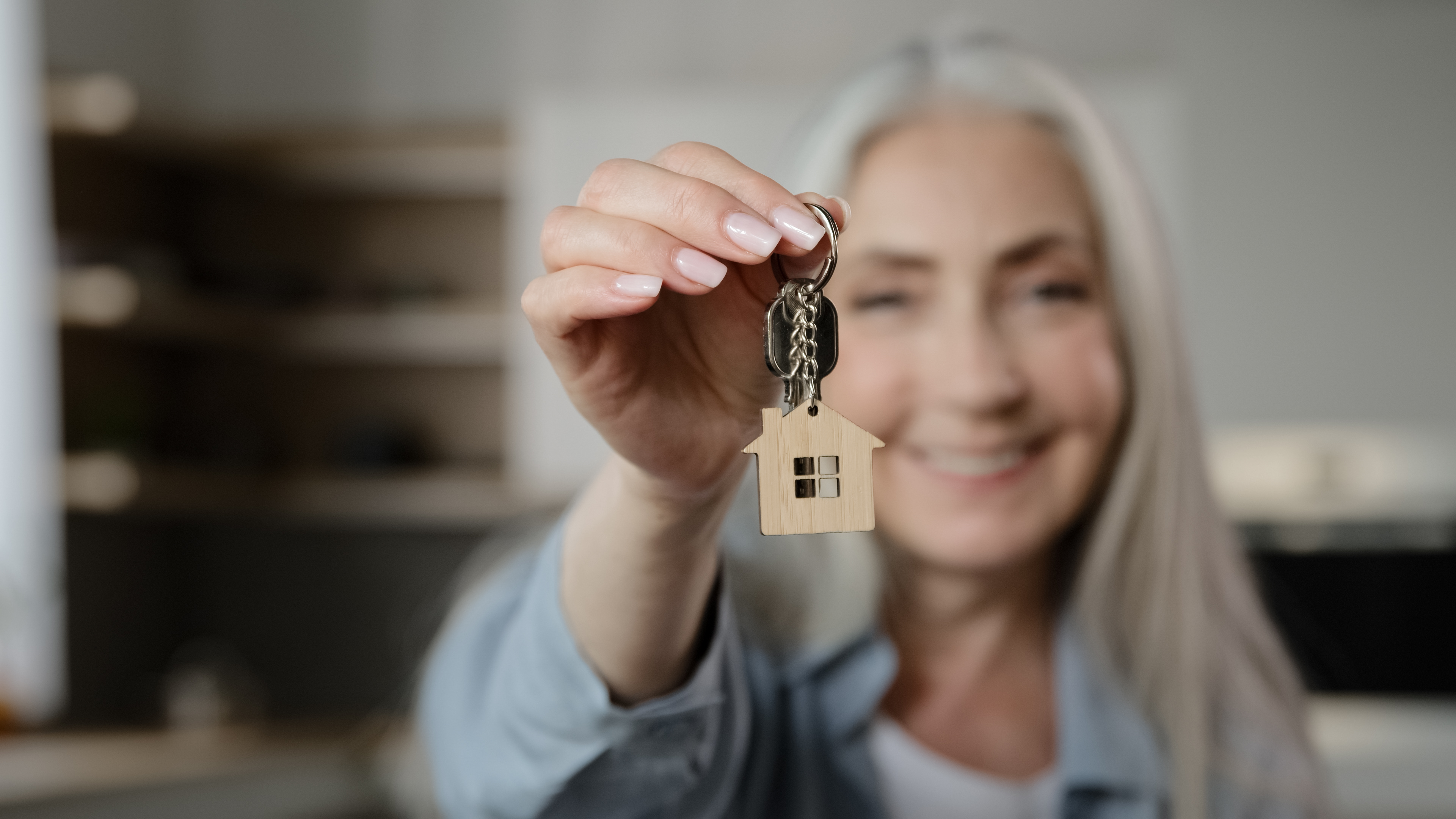 Older woman getting keys to new home