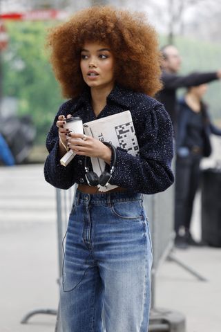 Actor Whitney Peak wearing a copper-toned afro