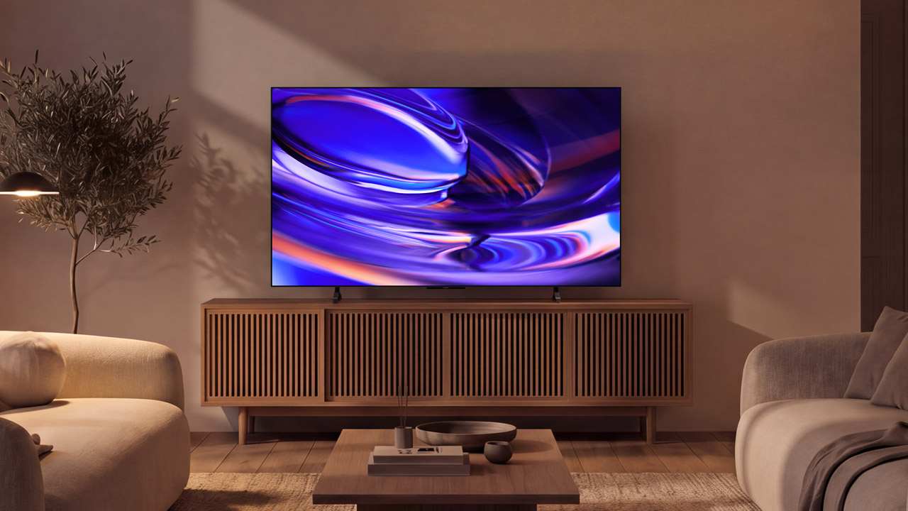 Sony Bravia 6 atop a dark wood TV unit in a cosily lit living room