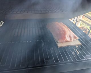 salmon being cooked on the Char-Griller Duo Combo Grill during testing
