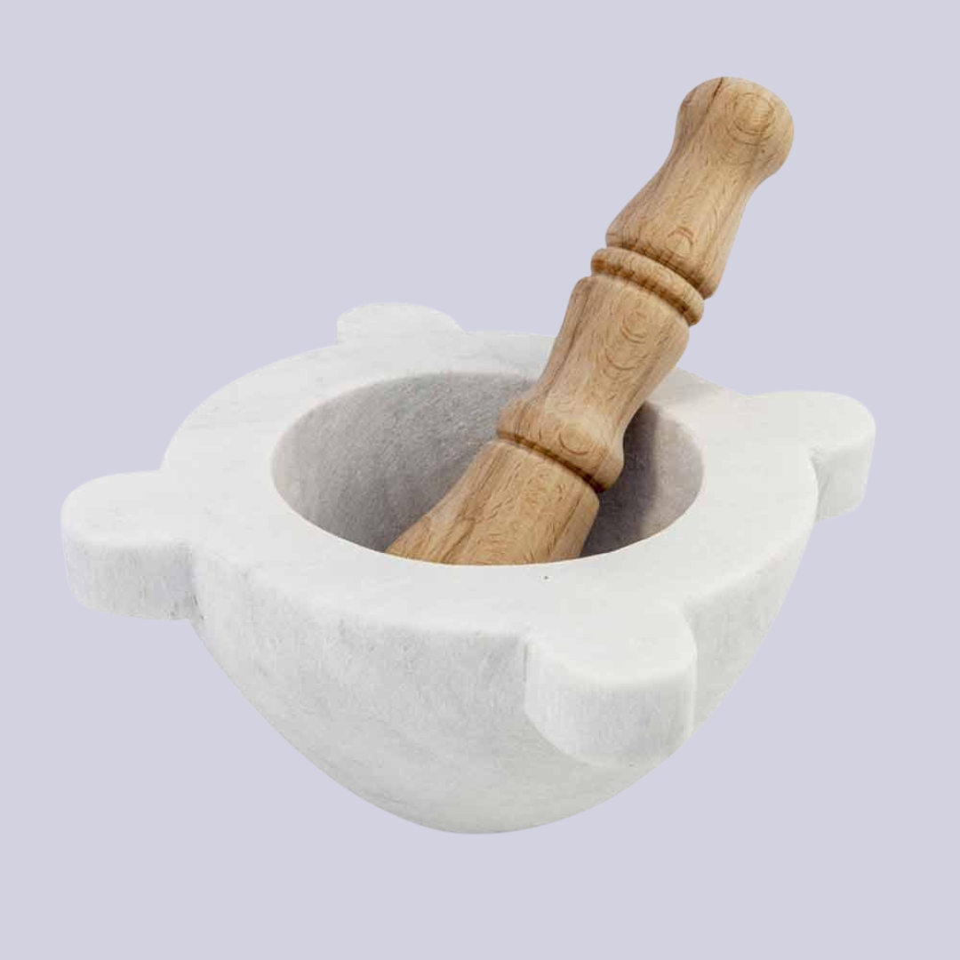 FiammettaV Home Collection Marble Mortar with Wooden Pestle against pale lilac background.