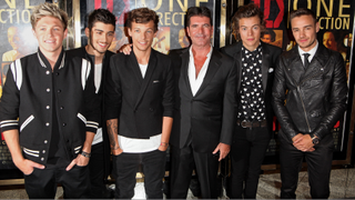  (L to R) Niall Horan, Zayn Malik, Louis Tomlinson, Simon Cowell, Harry Styles and Liam Payne smiling and standing together at the World Premiere of 'One Direction: This Is Us 3D' at Empire Leicester Square on August 20, 2013 in London, England.