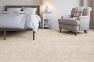 Low pile cream carpet in bedroom with armchair