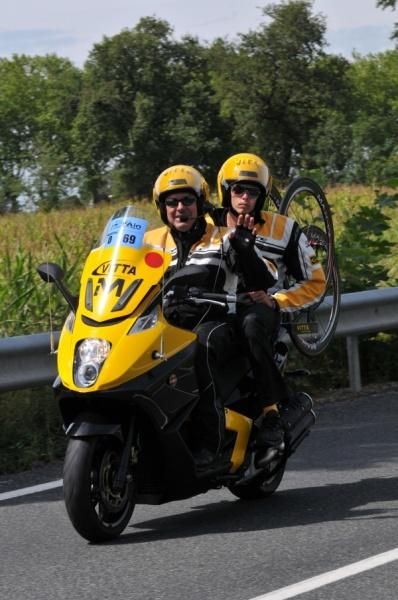 A friendly wave from a neutral support motorcycle.
