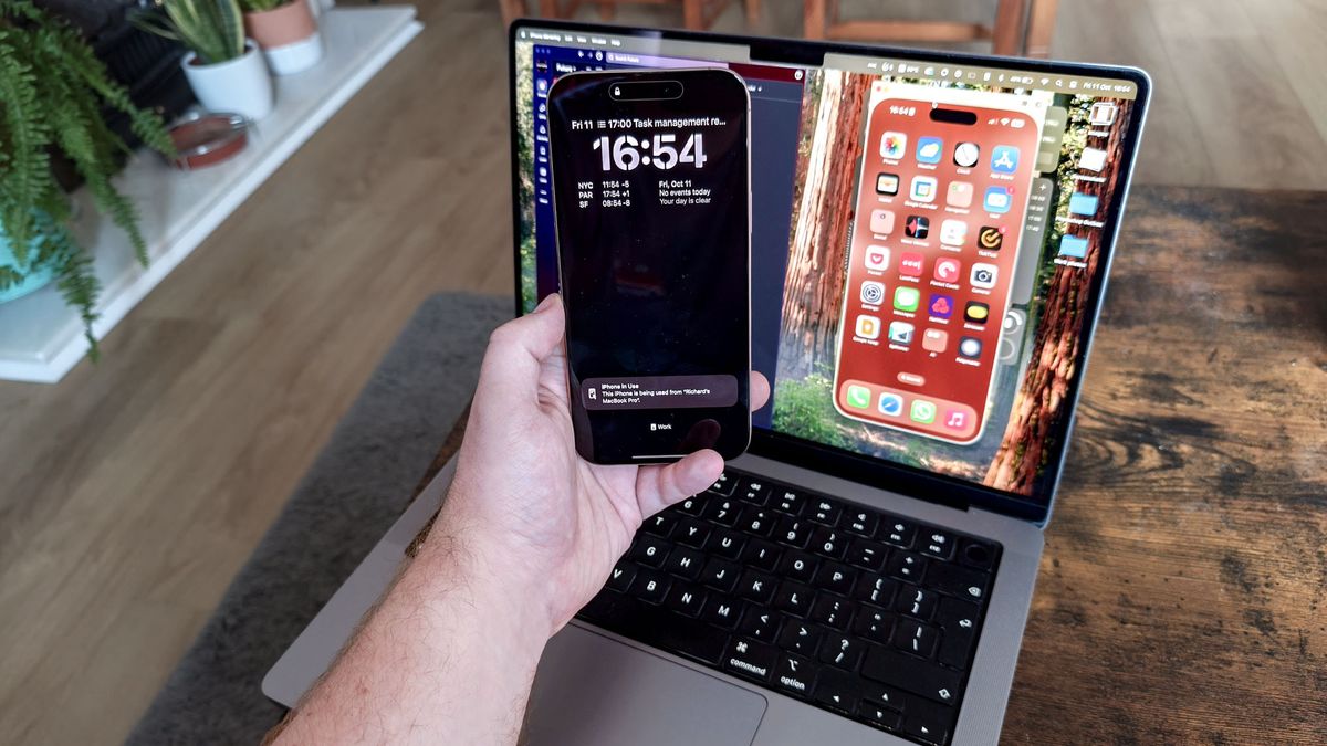 An iPhone 16 Pro Max being mirrored to a MacBook Pro