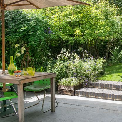 Patio with brick steps and floral patio edging
