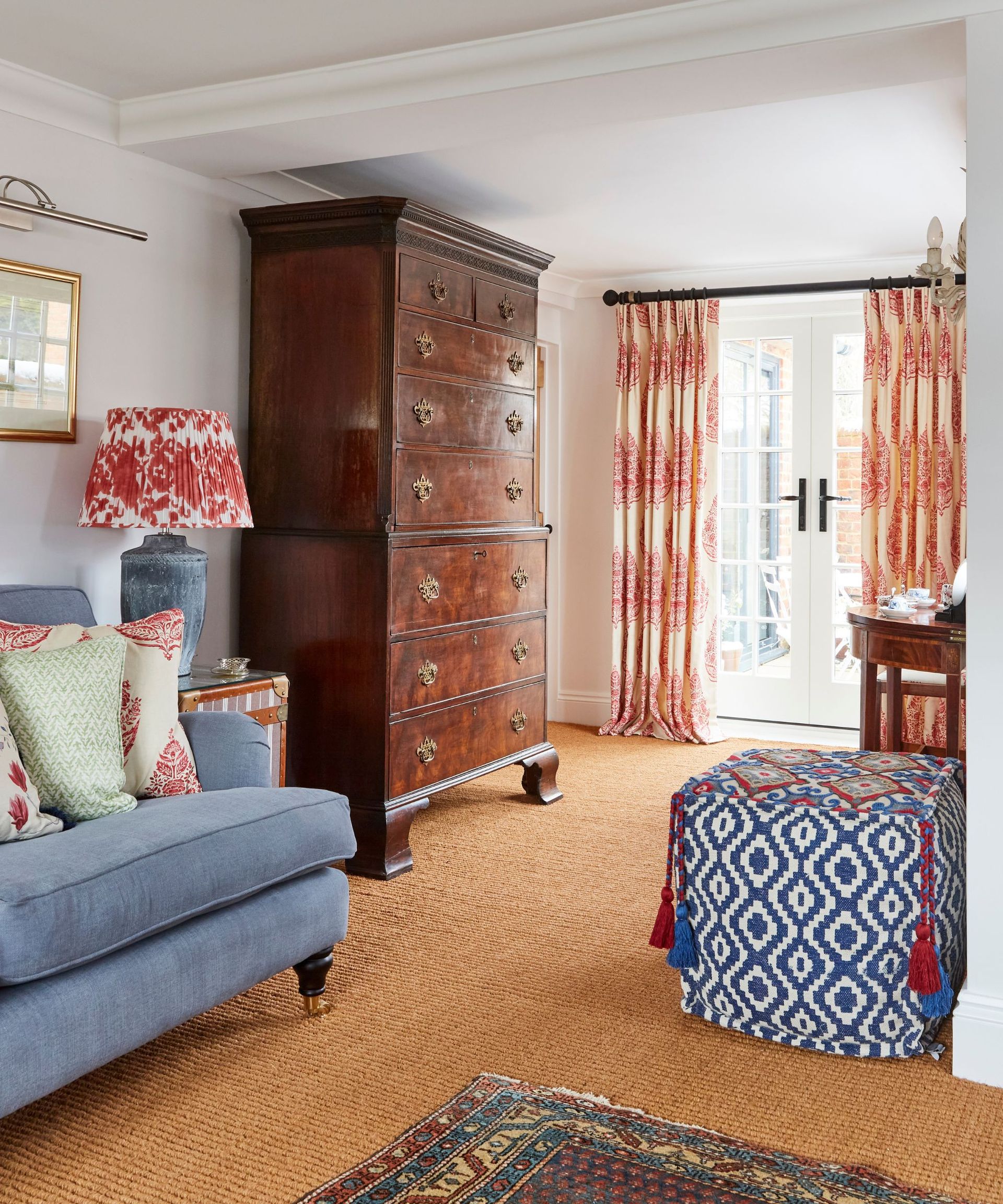 Wooden cabinet, blue sofa and footstool